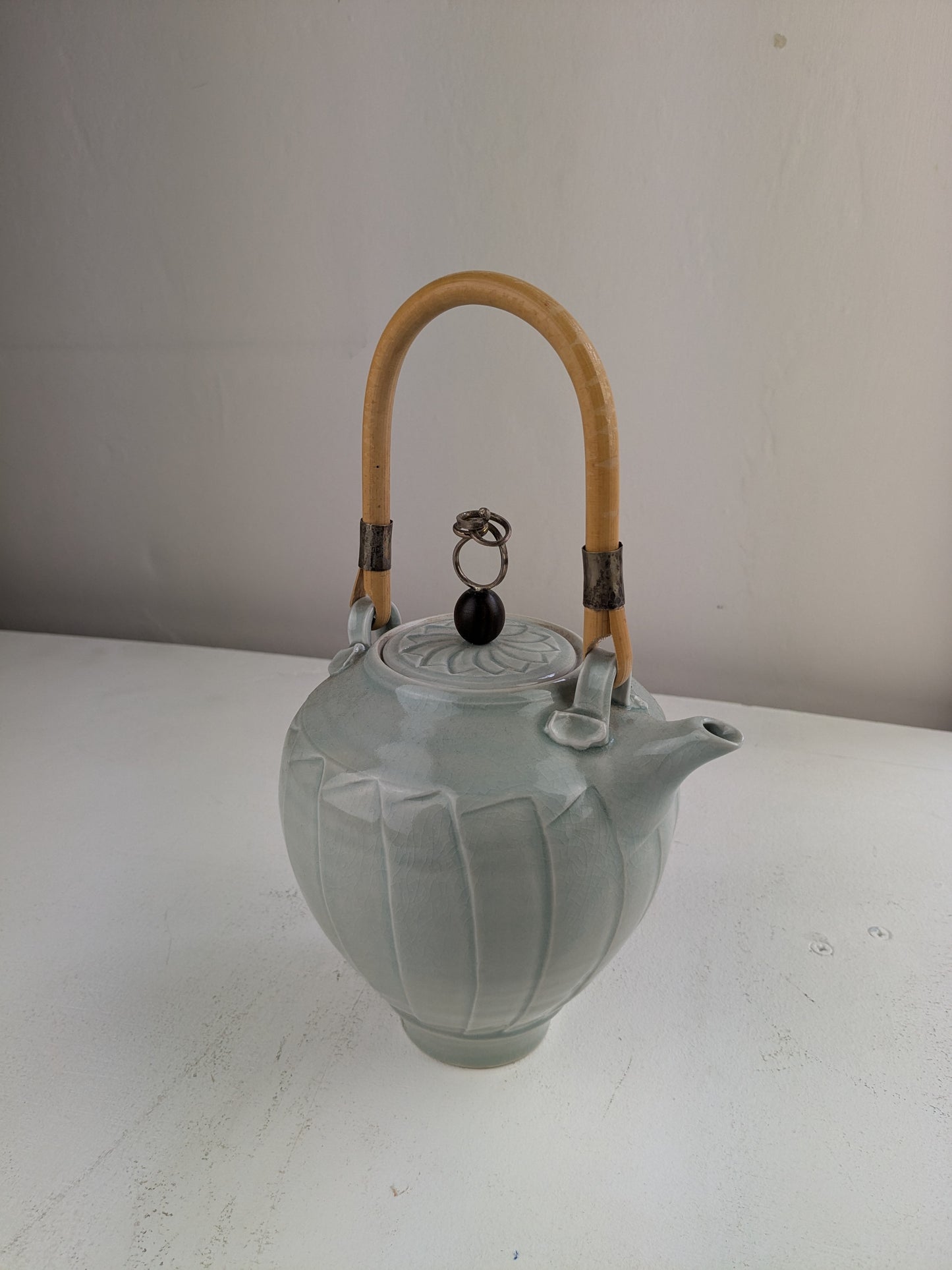 celadon teapot with silver set up